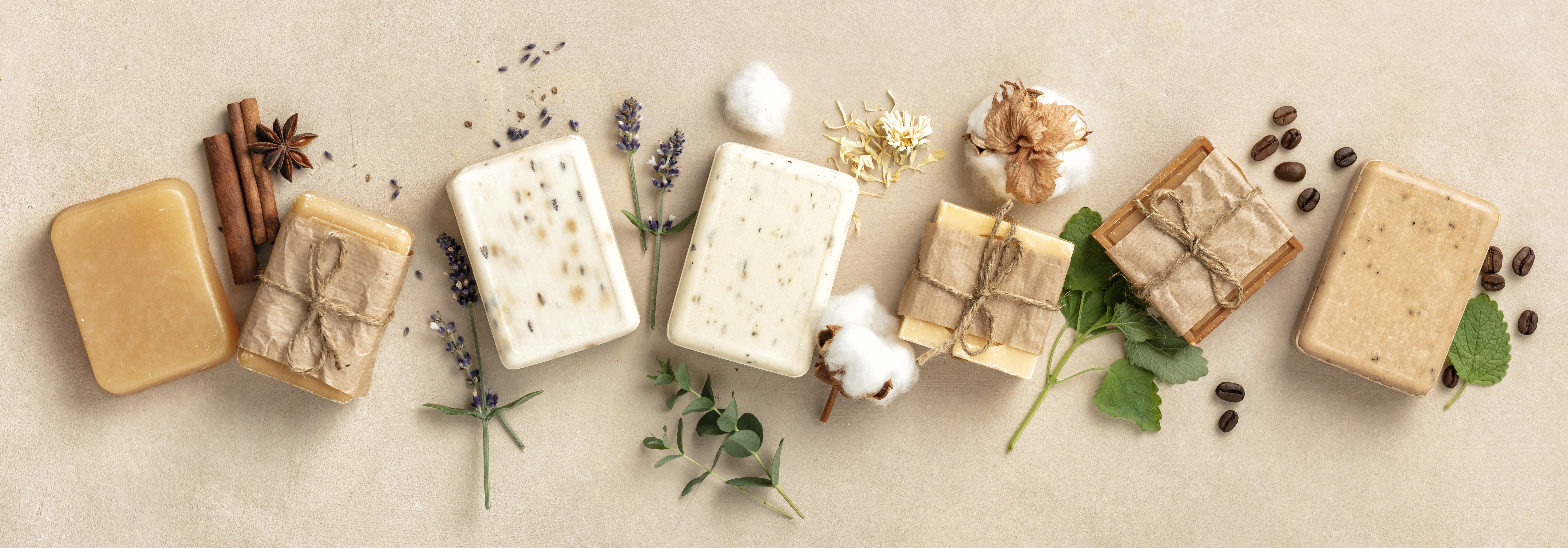 Beautiful Natural soap bars and ingredients on beige background, top view. Handmade organic soap concept, banner